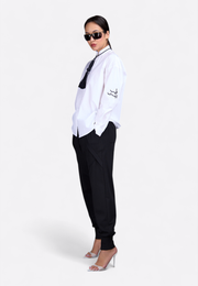 Model wearing classic shirt with decorative tassel, side pose – East Vibe